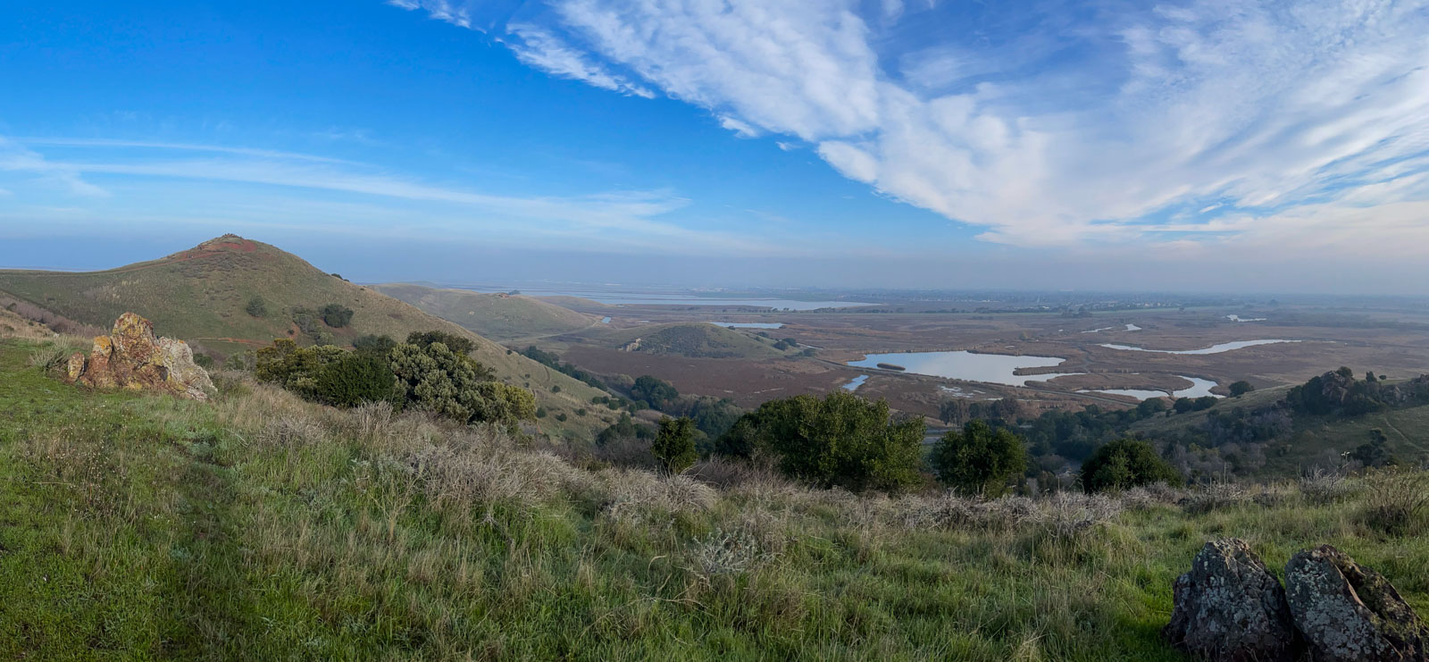 Panoramic autumn view of grassland and blue sky from a hilltop at Coyote Hills